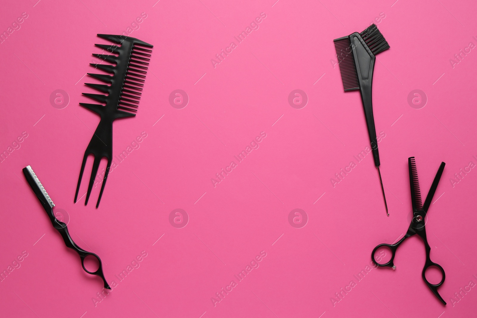 Photo of Different hairdresser's tools on pink background, flat lay. Space for text