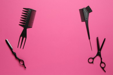Photo of Different hairdresser's tools on pink background, flat lay. Space for text