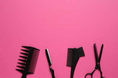 Photo of Different hairdresser's tools on pink background, flat lay. Space for text