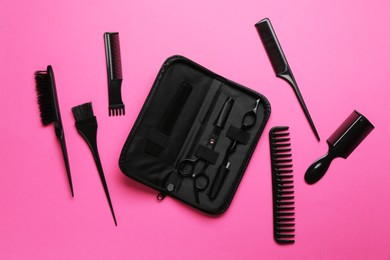 Photo of Different hairdresser's tools on pink background, flat lay