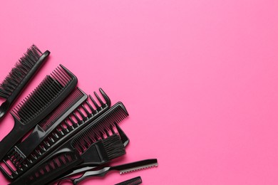 Photo of Different hairdresser's tools on pink background, flat lay. Space for text