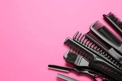 Photo of Different hairdresser's tools on pink background, above view. Space for text