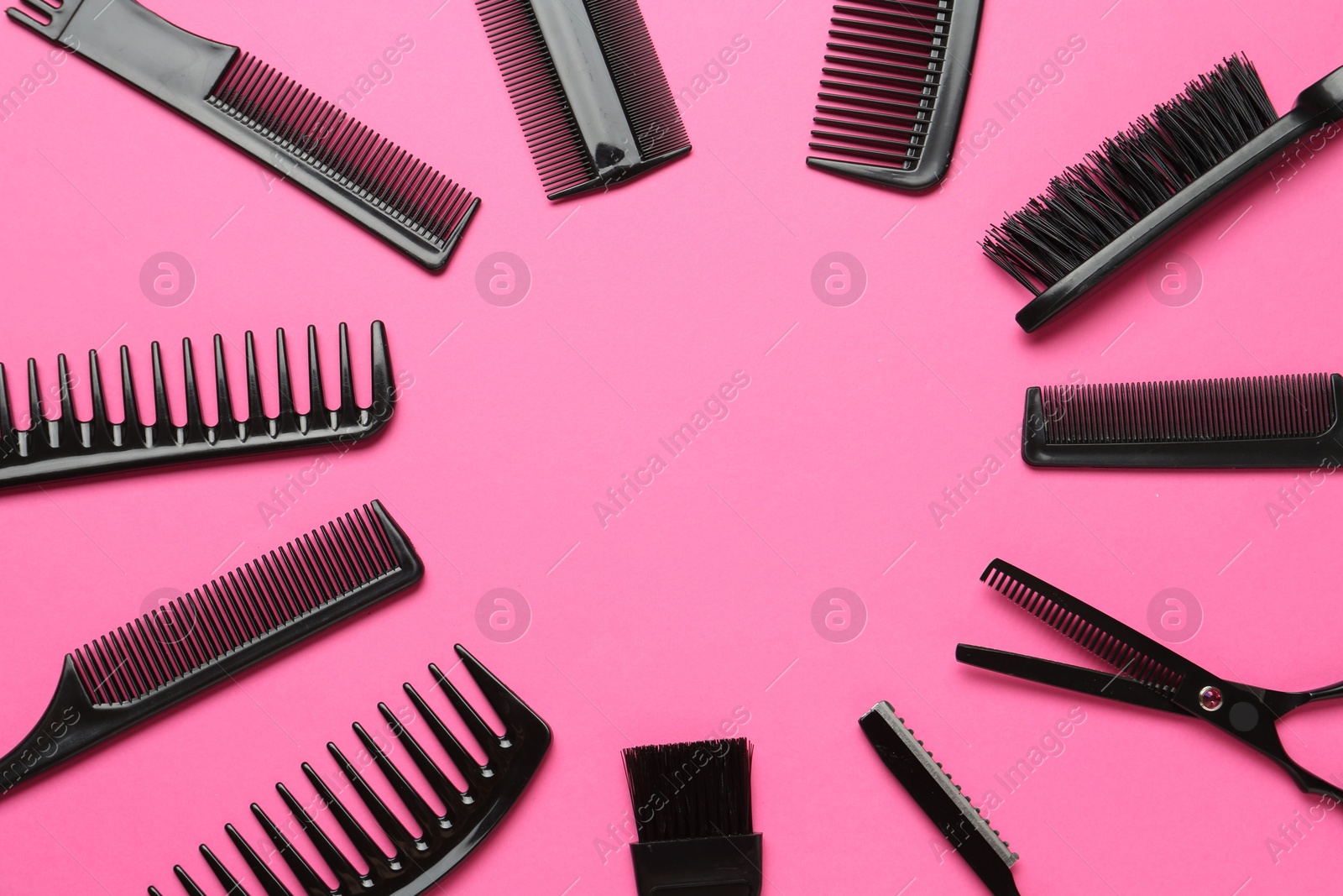 Photo of Frame of different hairdresser's tools on pink background, flat lay. Space for text
