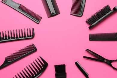 Photo of Frame of different hairdresser's tools on pink background, flat lay. Space for text