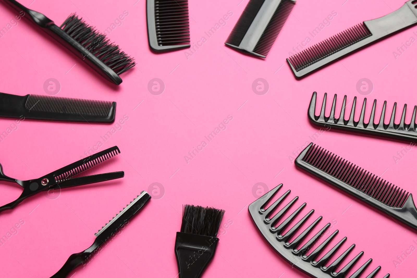 Photo of Frame of different hairdresser's tools on pink background, flat lay. Space for text