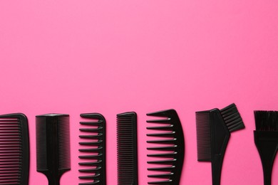 Photo of Different hairdresser's tools on pink background, flat lay. Space for text