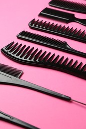 Photo of Different hairdresser's tools on pink background, closeup