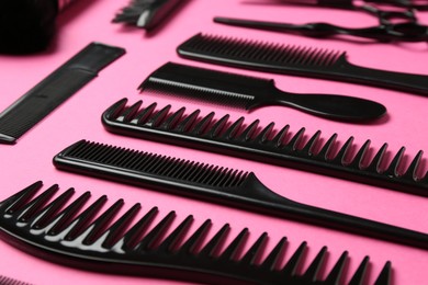 Photo of Different hairdresser's tools on pink background, closeup