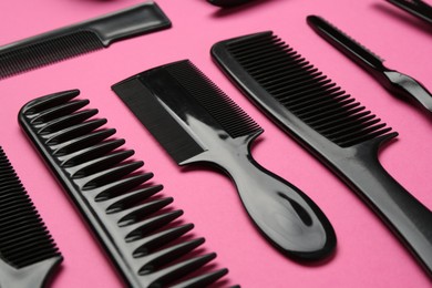 Photo of Different hairdresser's tools on pink background, closeup