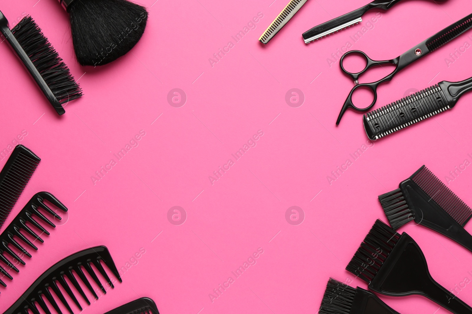 Photo of Frame of different hairdresser's tools on pink background, flat lay. Space for text