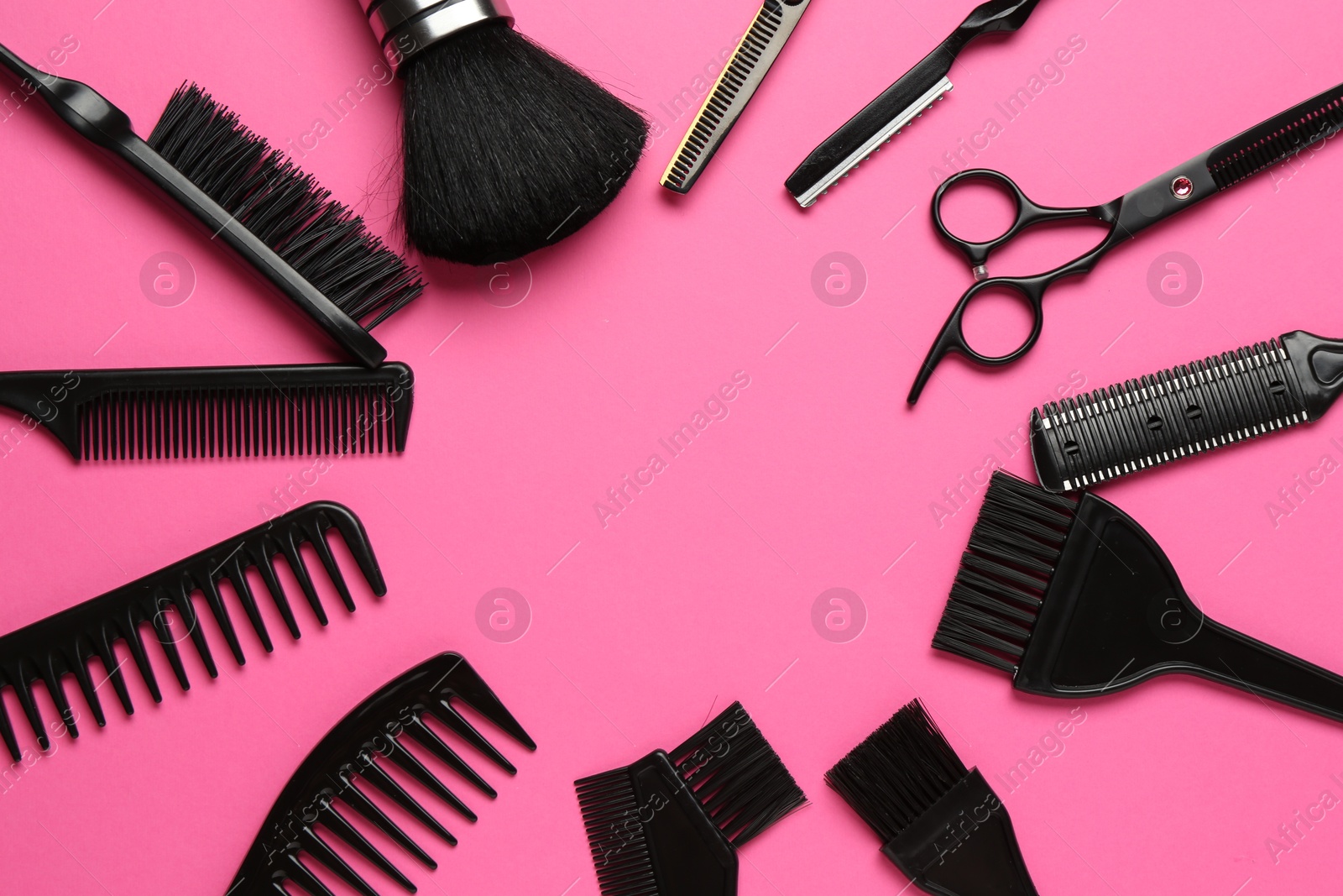 Photo of Frame of different hairdresser's tools on pink background, flat lay. Space for text