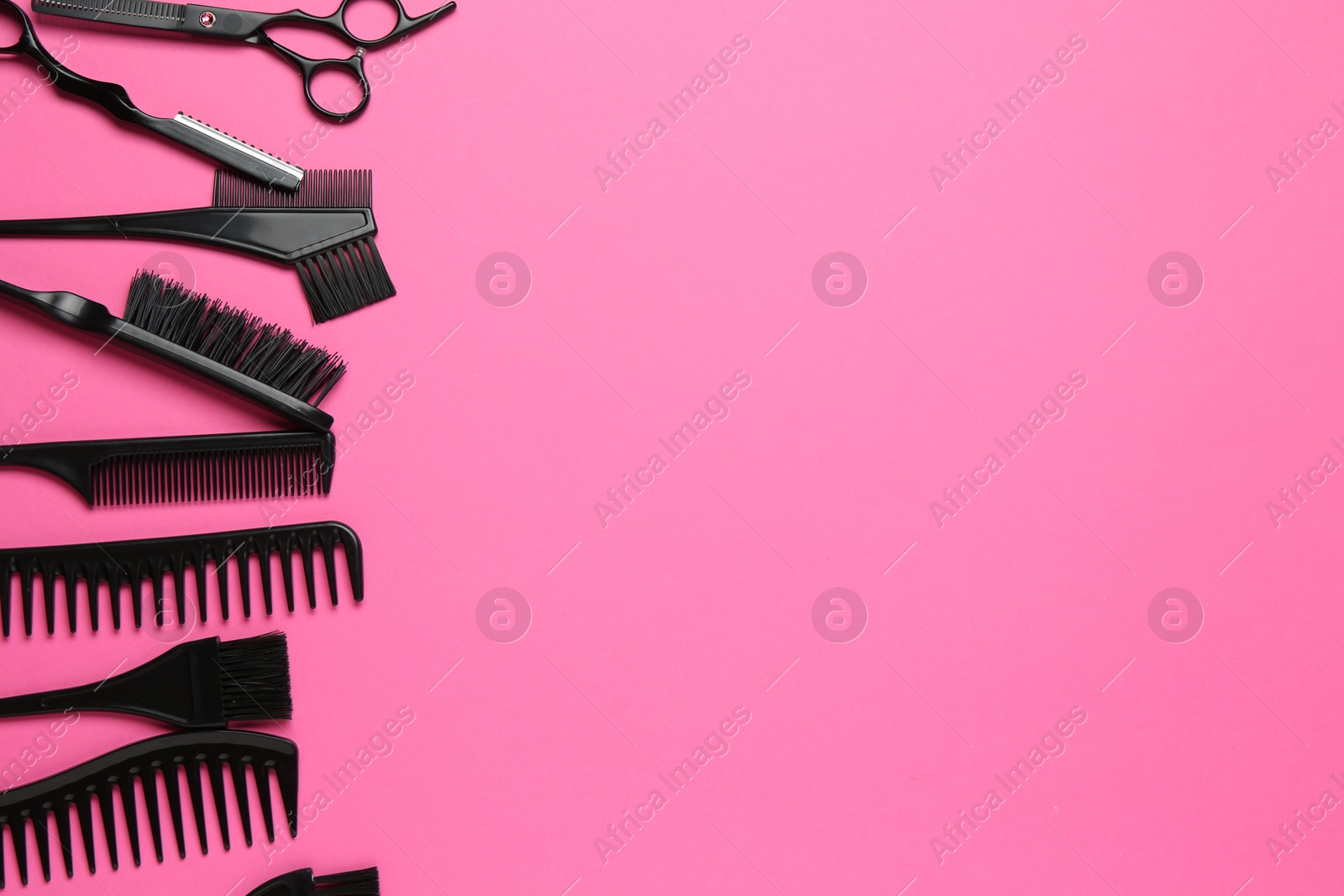 Different hairdresser's tools on pink background, flat lay. Space for text Photo of Different hairdresser's tools on pink background, flat lay. Space for text