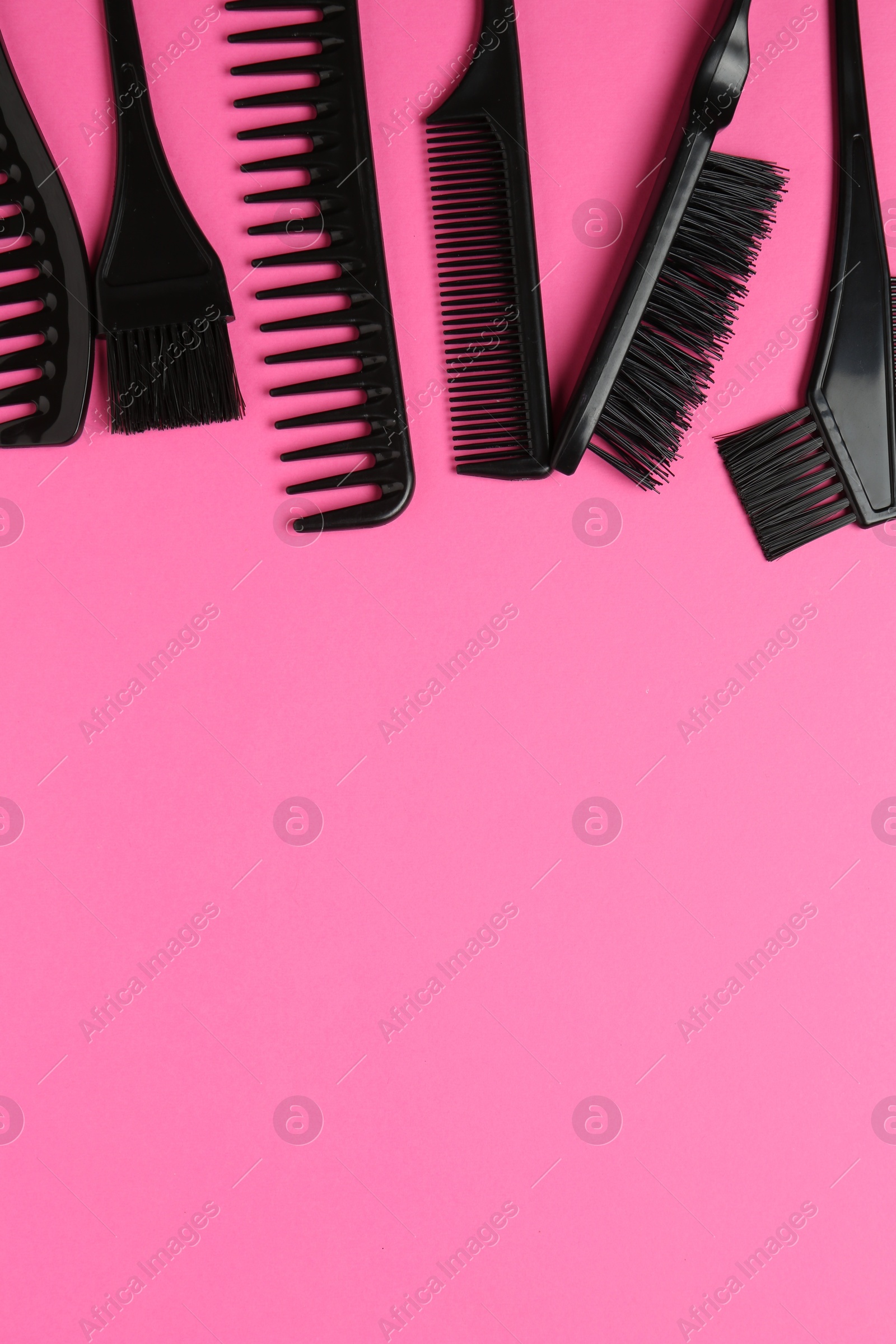 Different hairdresser's tools on pink background, flat lay. Space for text Photo of Different hairdresser's tools on pink background, flat lay. Space for text