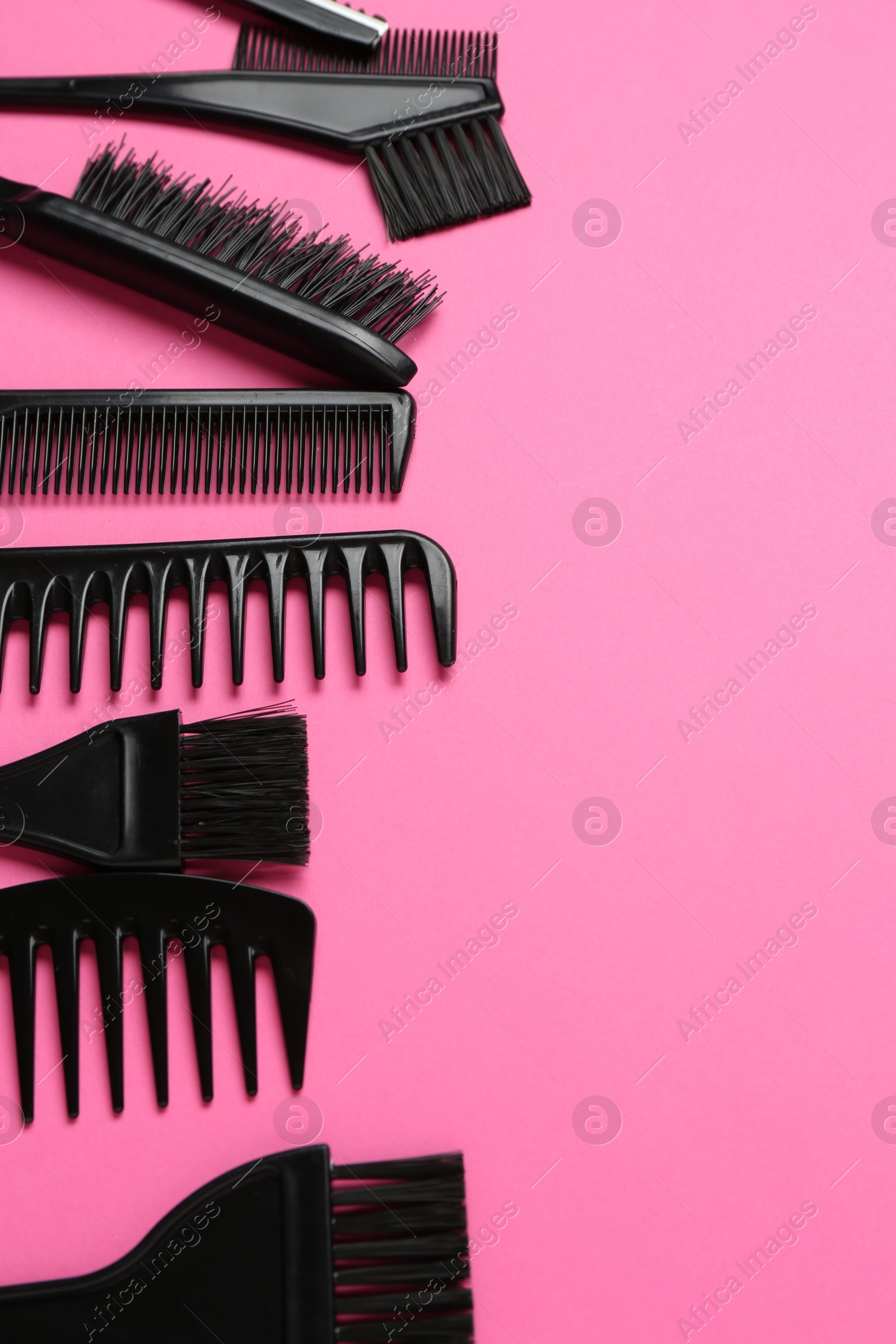 Different hairdresser's tools on pink background, flat lay. Space for text Photo of Different hairdresser's tools on pink background, flat lay. Space for text