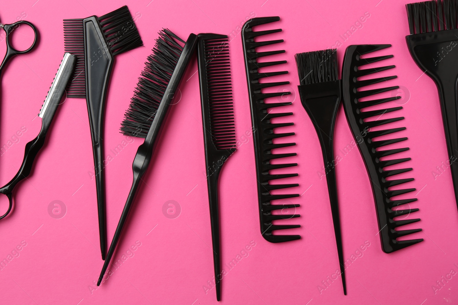 Different hairdresser's tools on pink background, flat lay Photo of Different hairdresser's tools on pink background, flat lay