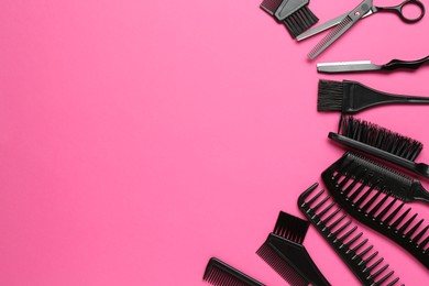Photo of Different hairdresser's tools on pink background, flat lay. Space for text