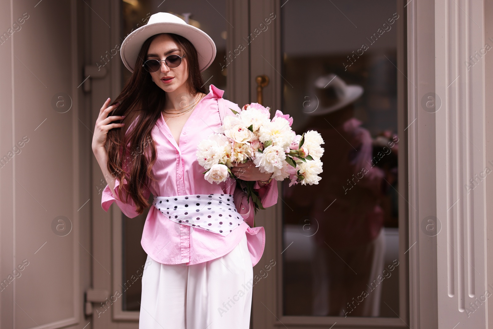 Photo of Stylish woman with bouquet of beautiful peonies outdoors