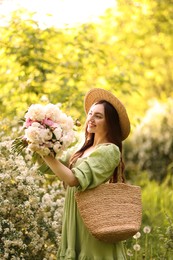 Photo of Beautiful woman with bouquet of peonies in park