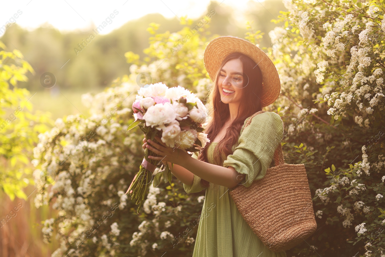 Beautiful woman with bouquet of peonies in park on sunny day. Space for text Photo of Beautiful woman with bouquet of peonies in park on sunny day. Space for text
