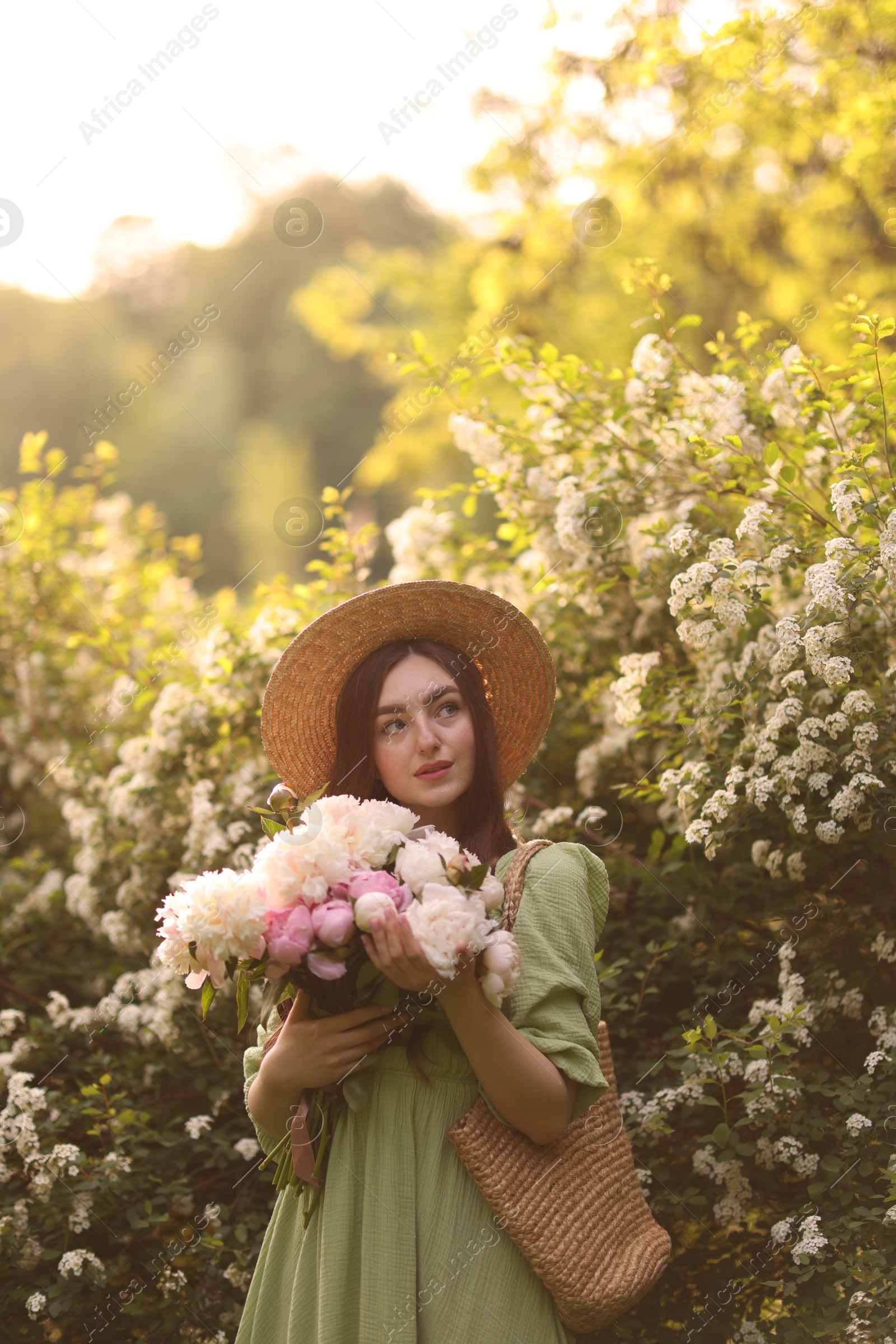 Beautiful woman with bouquet of peonies in park on sunny day. Space for text Photo of Beautiful woman with bouquet of peonies in park on sunny day. Space for text