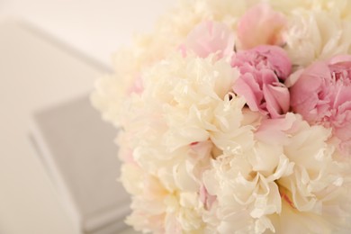 Photo of Bouquet of beautiful peonies on blurred background, closeup