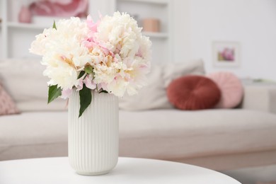 Photo of Bouquet of beautiful peonies on table indoors. Space for text