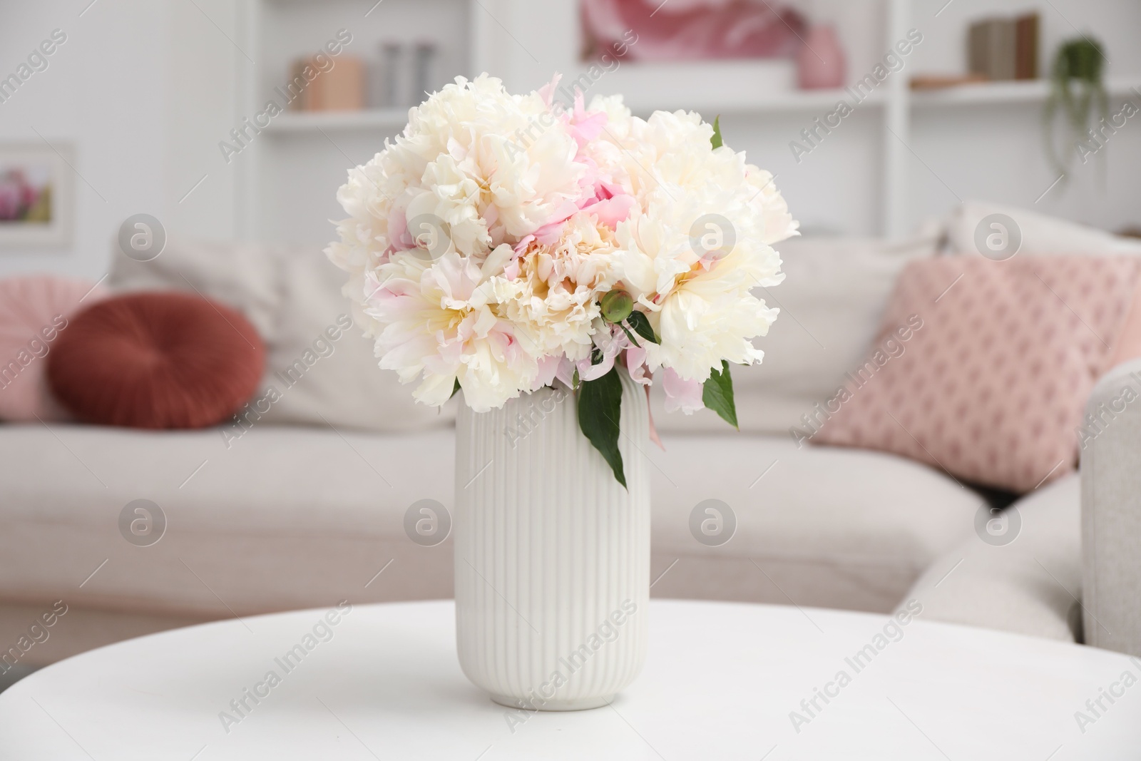 Bouquet of beautiful peonies on table indoors Photo of Bouquet of beautiful peonies on table indoors