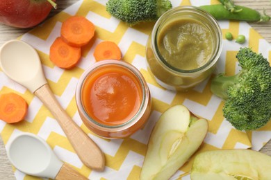 Photo of Baby food. Tasty puree in glass jars and ingredients on table, flat lay