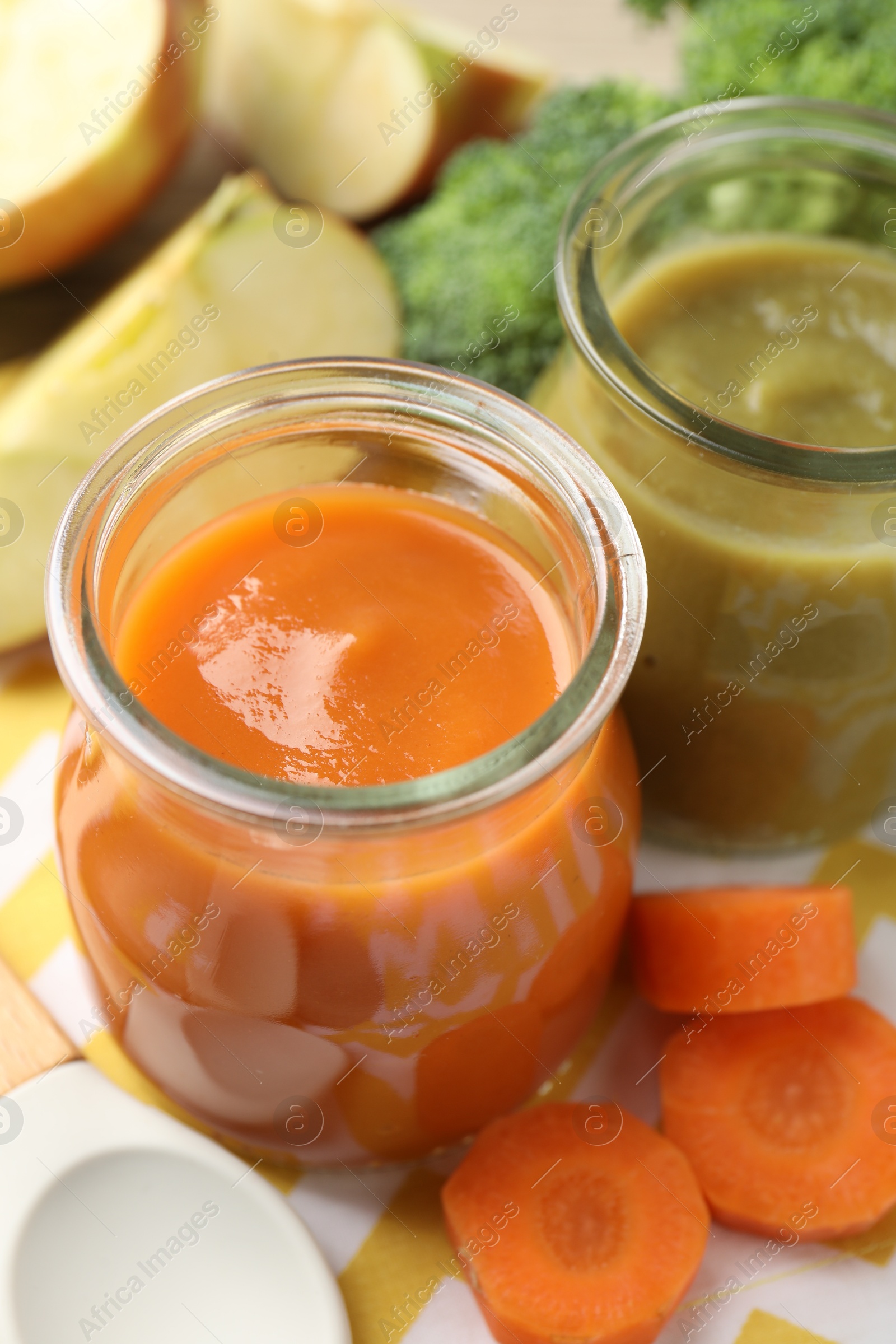 Baby food. Tasty puree in glass jars and ingredients on table, closeup Photo of Baby food. Tasty puree in glass jars and ingredients on table, closeup