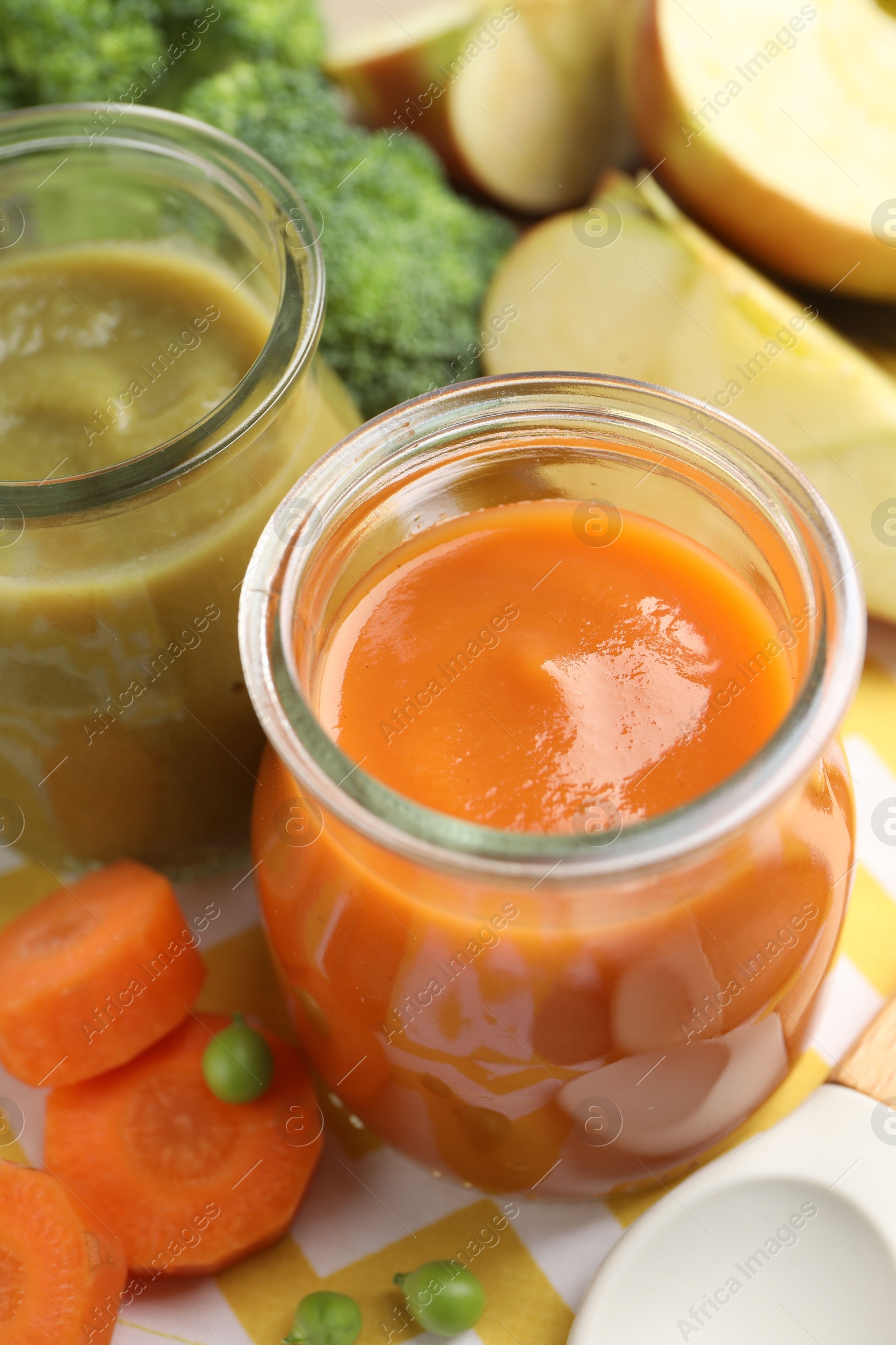 Baby food. Tasty puree in glass jars and ingredients on table, closeup Photo of Baby food. Tasty puree in glass jars and ingredients on table, closeup