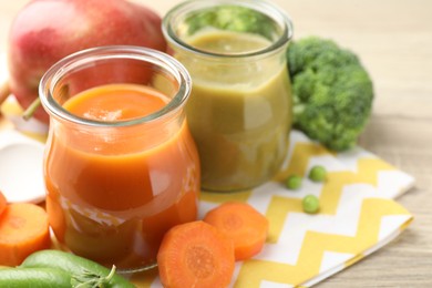 Photo of Baby food. Tasty puree in glass jars and ingredients on table, closeup. Space for text