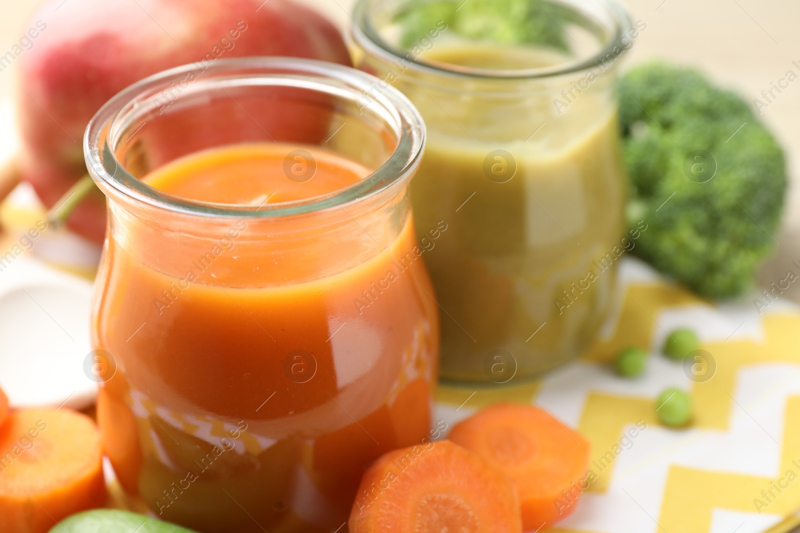 Baby food. Tasty puree in glass jars and ingredients on table, closeup. Space for text Photo of Baby food. Tasty puree in glass jars and ingredients on table, closeup. Space for text
