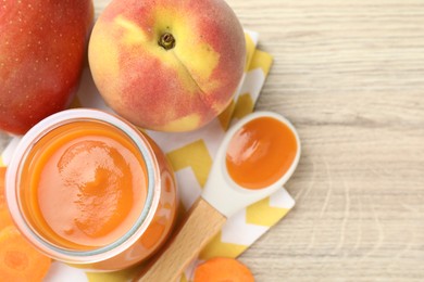 Photo of Baby food. Tasty puree in jar, ingredients and spoon on wooden table, flat lay. Space for text