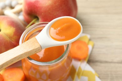 Photo of Baby food. Tasty puree in jar, ingredients and spoon on table, closeup. Space for text