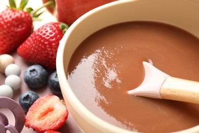 Photo of Baby food. Tasty puree in bowl and ingredients on table, closeup