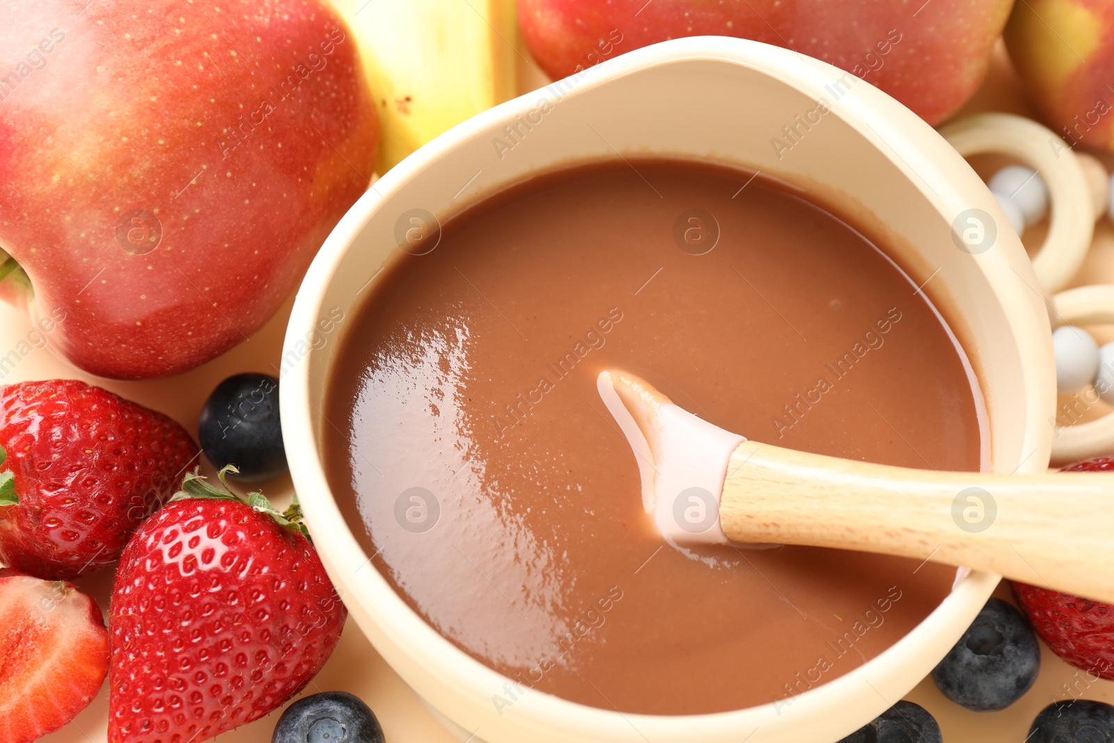 Baby food. Tasty puree in bowl and ingredients on table, above view Photo of Baby food. Tasty puree in bowl and ingredients on table, above view