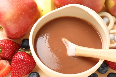 Photo of Baby food. Tasty puree in bowl and ingredients on table, above view