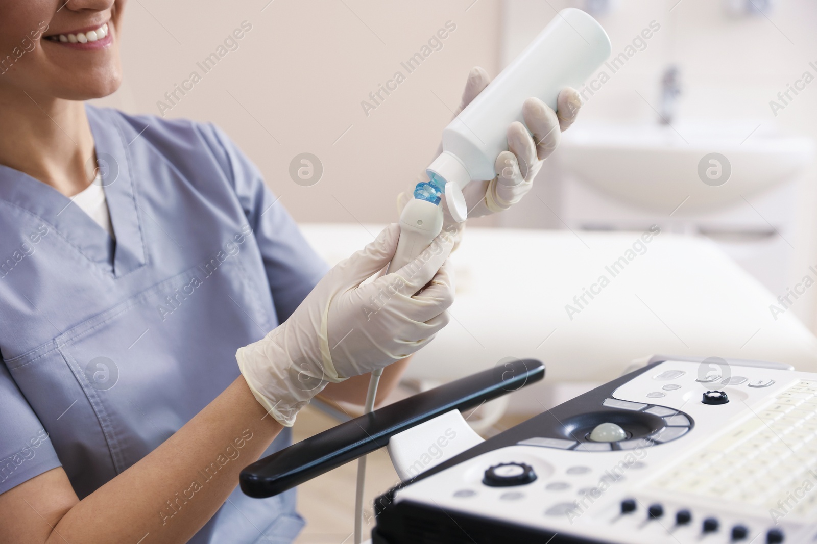 Sonographer applying gel on ultrasound transducer in clinic, closeup Photo of Sonographer applying gel on ultrasound transducer in clinic, closeup