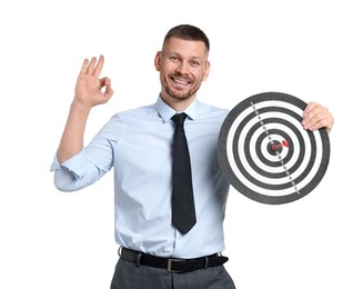 Photo of Targeting. Man with dart board and arrow showing ok gesture on white background