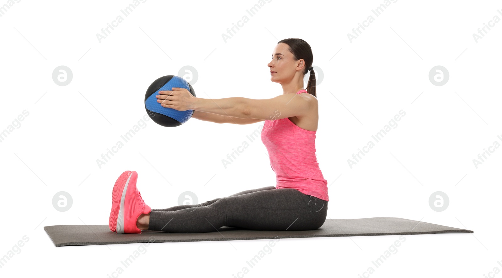 Athletic woman exercising with medicine ball on white background Photo of Athletic woman exercising with medicine ball on white background