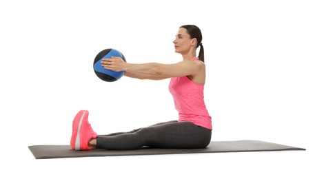 Photo of Athletic woman exercising with medicine ball on white background
