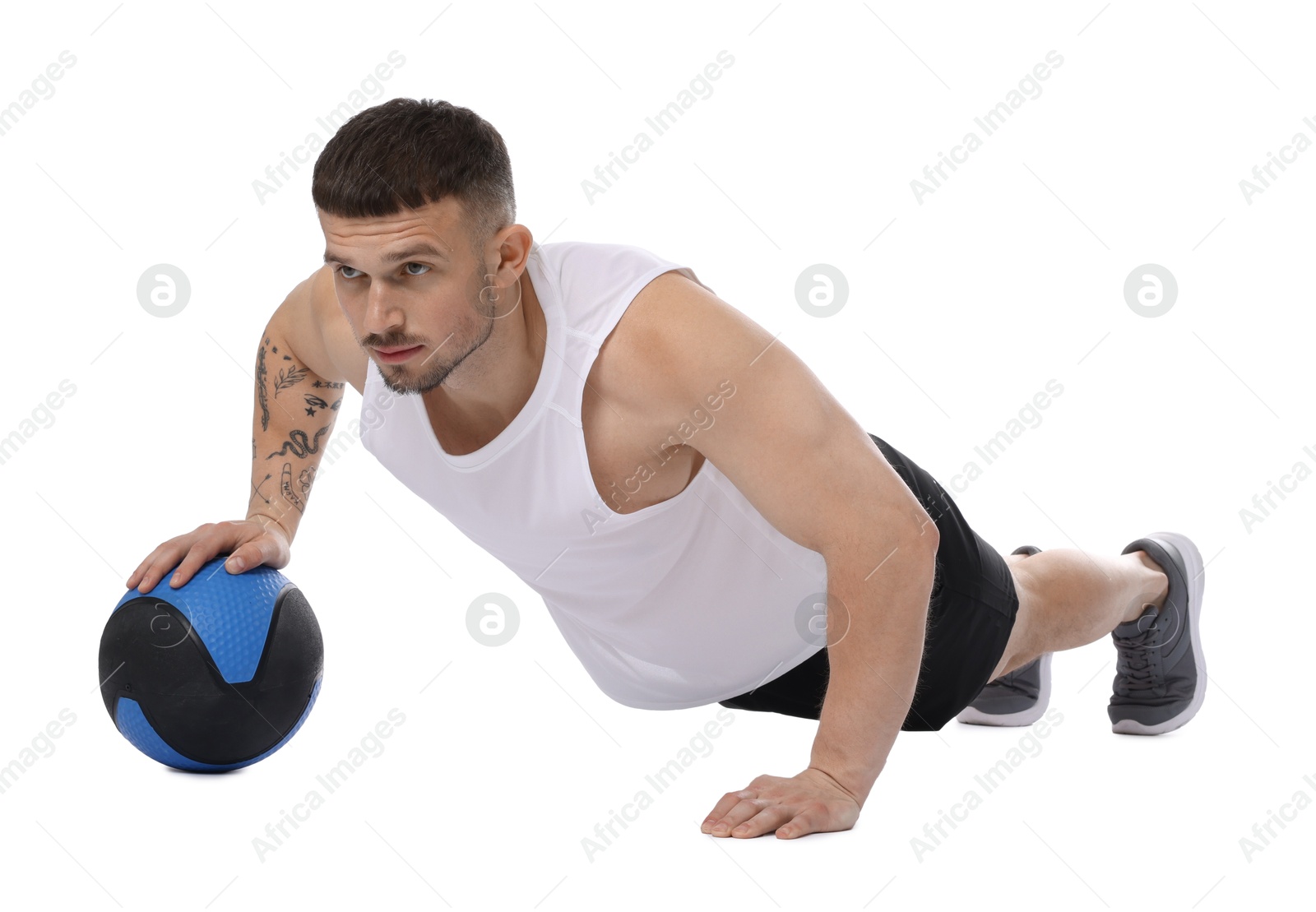 Man exercising with medicine ball on white background Photo of Man exercising with medicine ball on white background