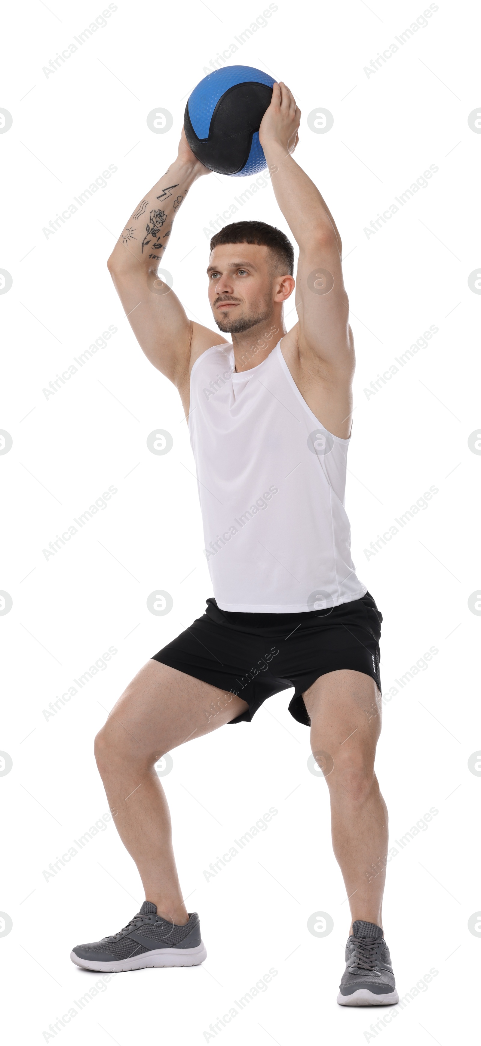 Man exercising with medicine ball on white background Photo of Man exercising with medicine ball on white background