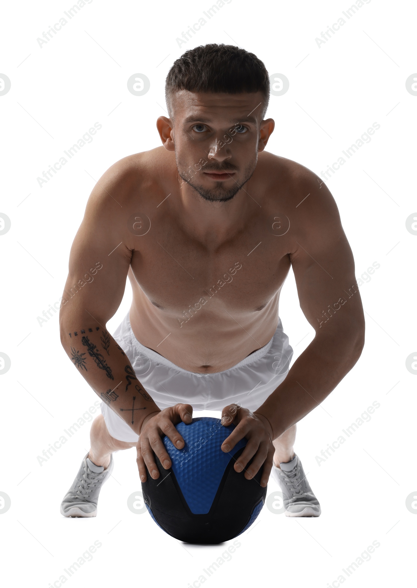 Man exercising with medicine ball on white background Photo of Man exercising with medicine ball on white background