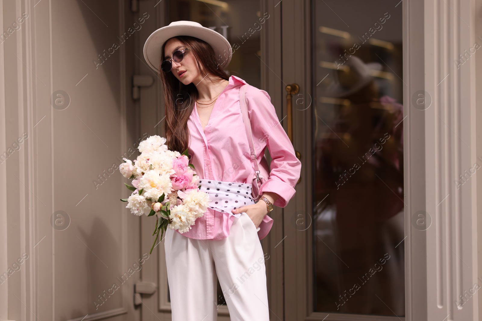 Stylish woman with bouquet of beautiful peonies outdoors Photo of Stylish woman with bouquet of beautiful peonies outdoors