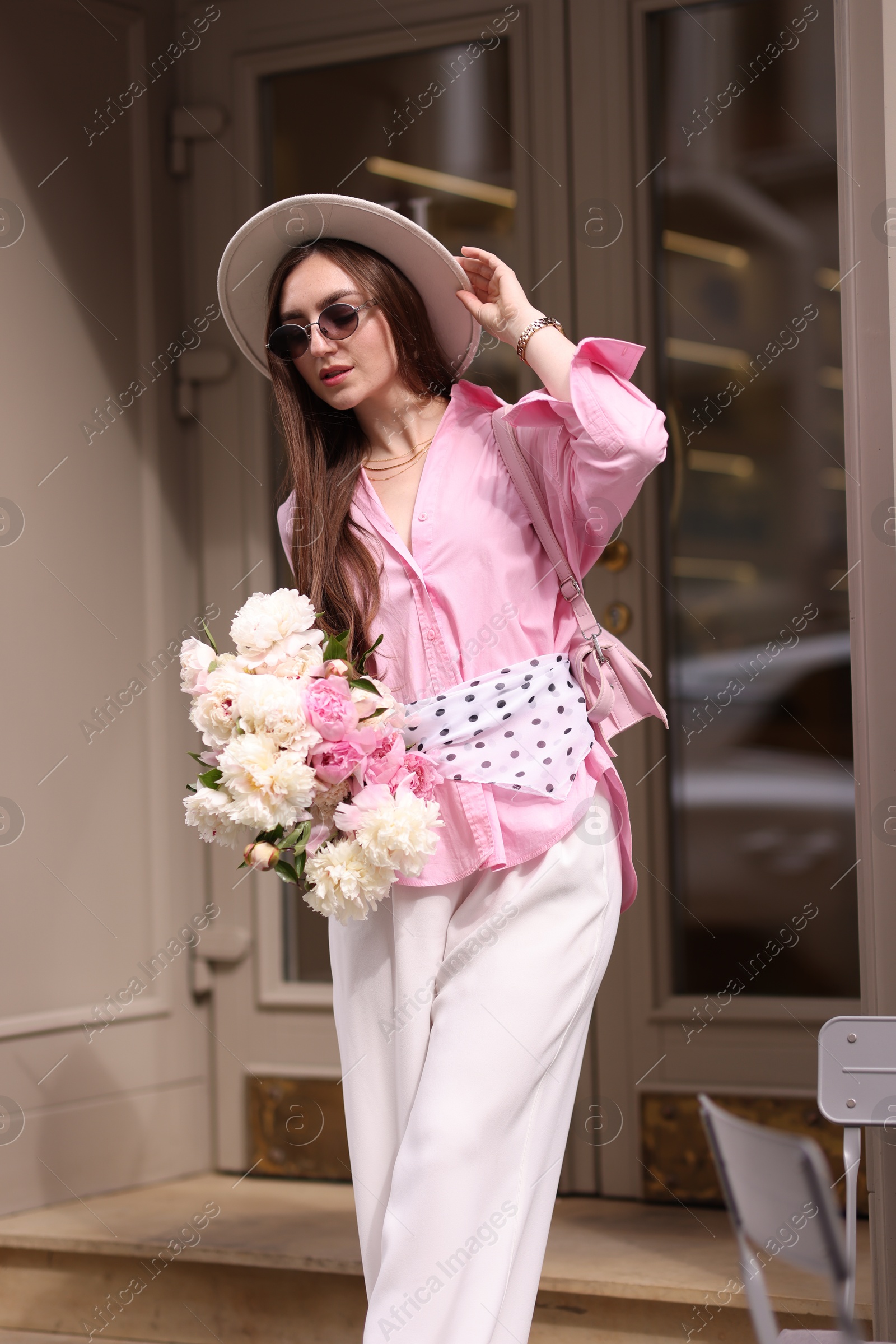 Stylish woman with bouquet of beautiful peonies outdoors Photo of Stylish woman with bouquet of beautiful peonies outdoors