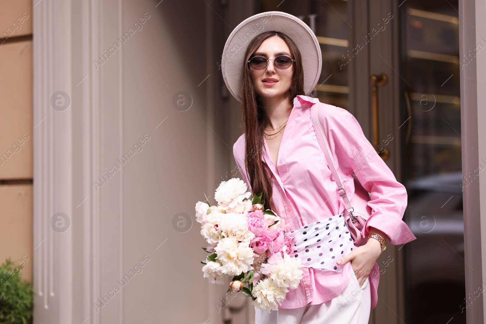 Stylish woman with bouquet of beautiful peonies outdoors. Space for text Photo of Stylish woman with bouquet of beautiful peonies outdoors. Space for text