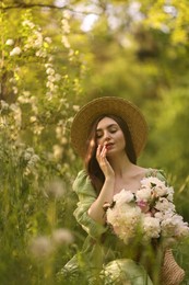 Photo of Beautiful woman with bouquet of peonies in park