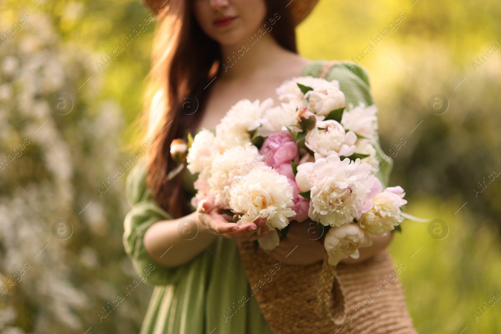 Beautiful woman with bouquet of peonies in park, closeup Photo of Beautiful woman with bouquet of peonies in park, closeup