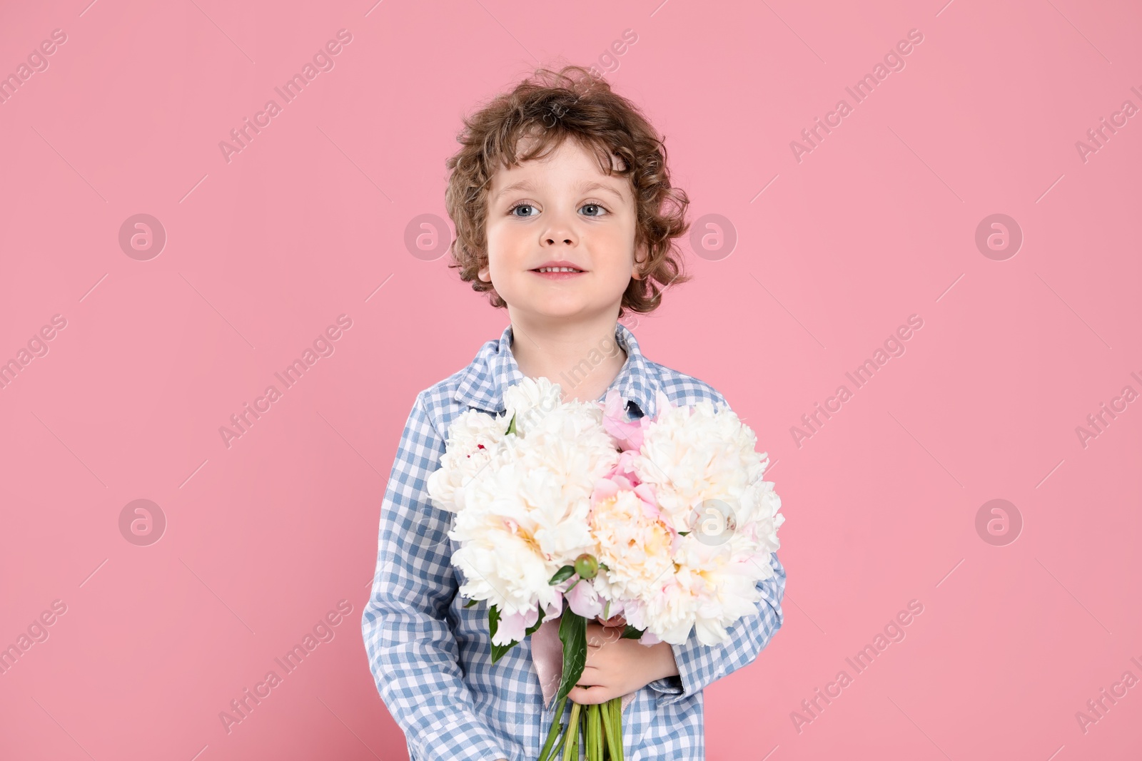 Cute little boy with bouquet of beautiful peonies on pink background Photo of Cute little boy with bouquet of beautiful peonies on pink background